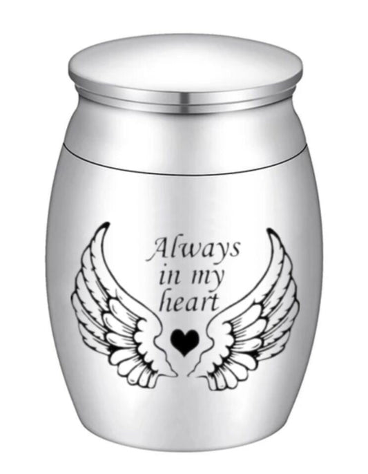 Pet memorial jar with engraved wings and heart, inscribed 'Always in my heart', a cherished keepsake.